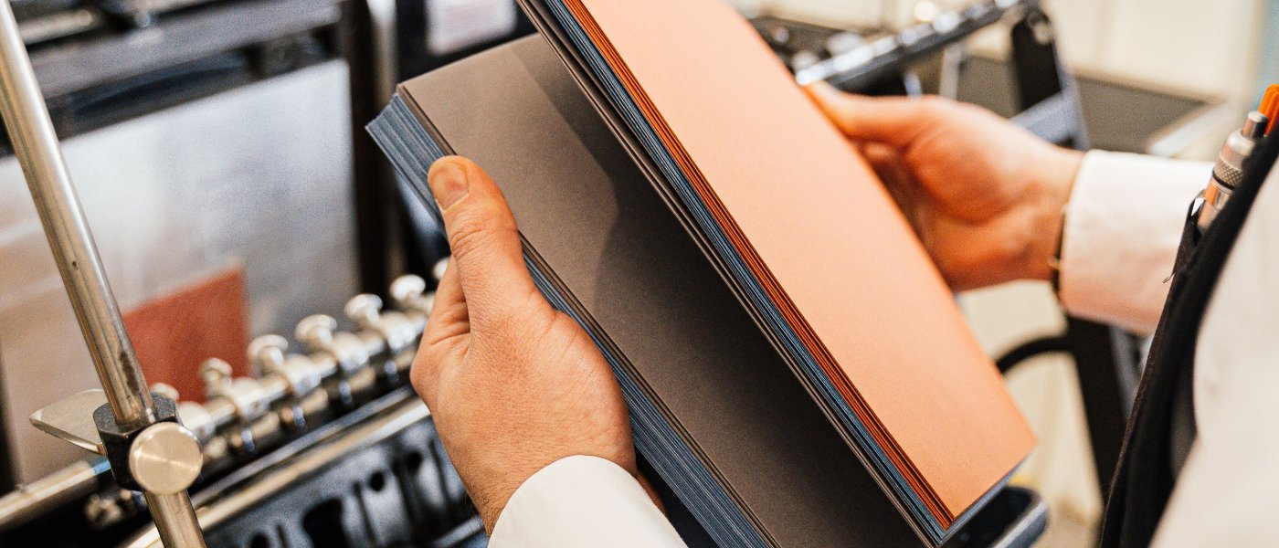 A pressman checking a run of coloured stock